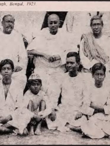 Group of men in white khadi photographed together; printed caption fragment reads Bengal, 1923.
