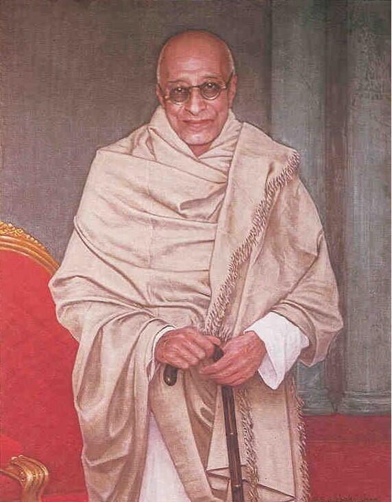 Painted state portrait of C. Rajagopalachari standing in a white shawl and dhoti, one hand resting on a walking stick, beside a red and gilt chair.