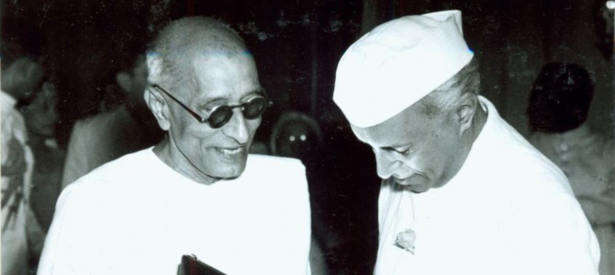 Rajaji in conversation with a fellow Congress leader, both in khadi.