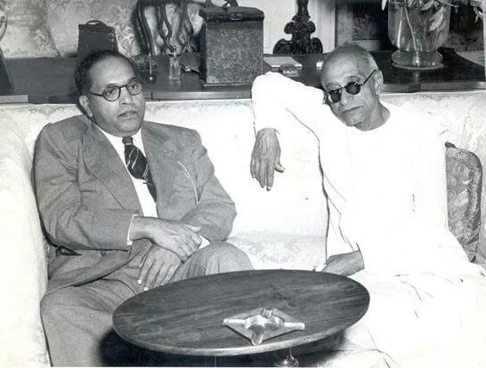 B. R. Ambedkar in a suit and C. Rajagopalachari in khadi seated together on a sofa.