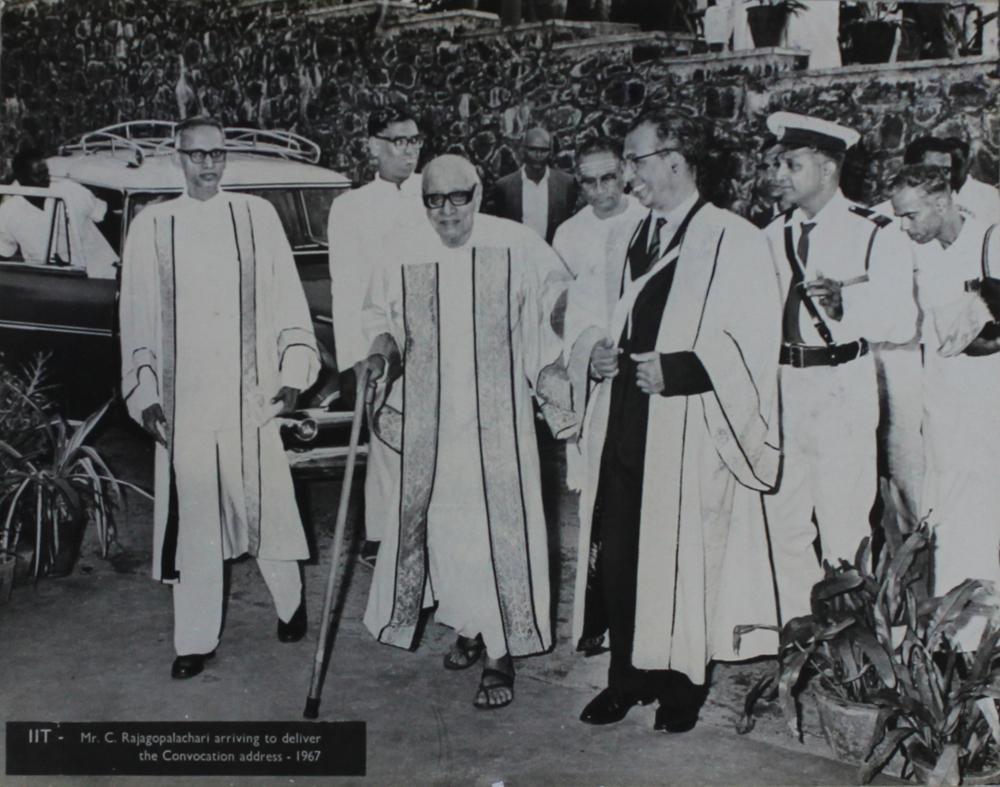 An elderly C. Rajagopalachari in academic robes, walking with a stick and accompanied by other robed officials, at an Indian Institute of Technology convocation in 1967.